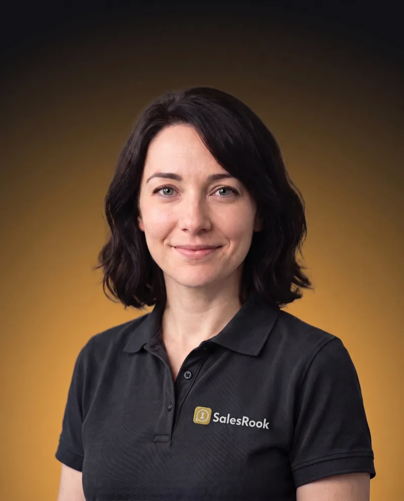 Sky, host of The Rook Report Radio Show, in a black SalesRook polo against a black-to-gold gradient